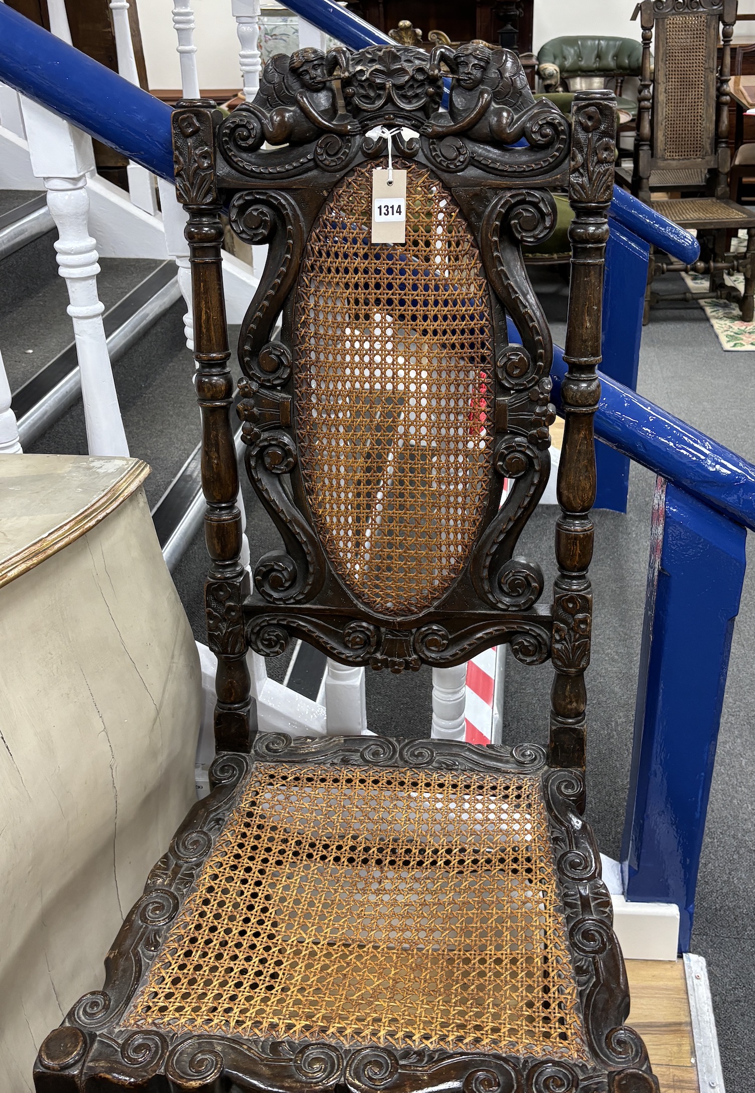A Charles II carved walnut caned seat and back dining chair, c.1670, width 54cm, height 120cm, Please note this lot attracts an additional import tax of 5% on the hammer price